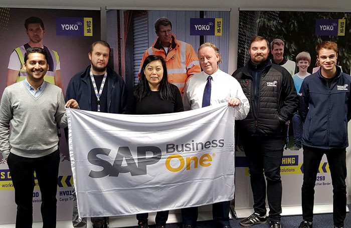 Yoko Int team holding SAP flag