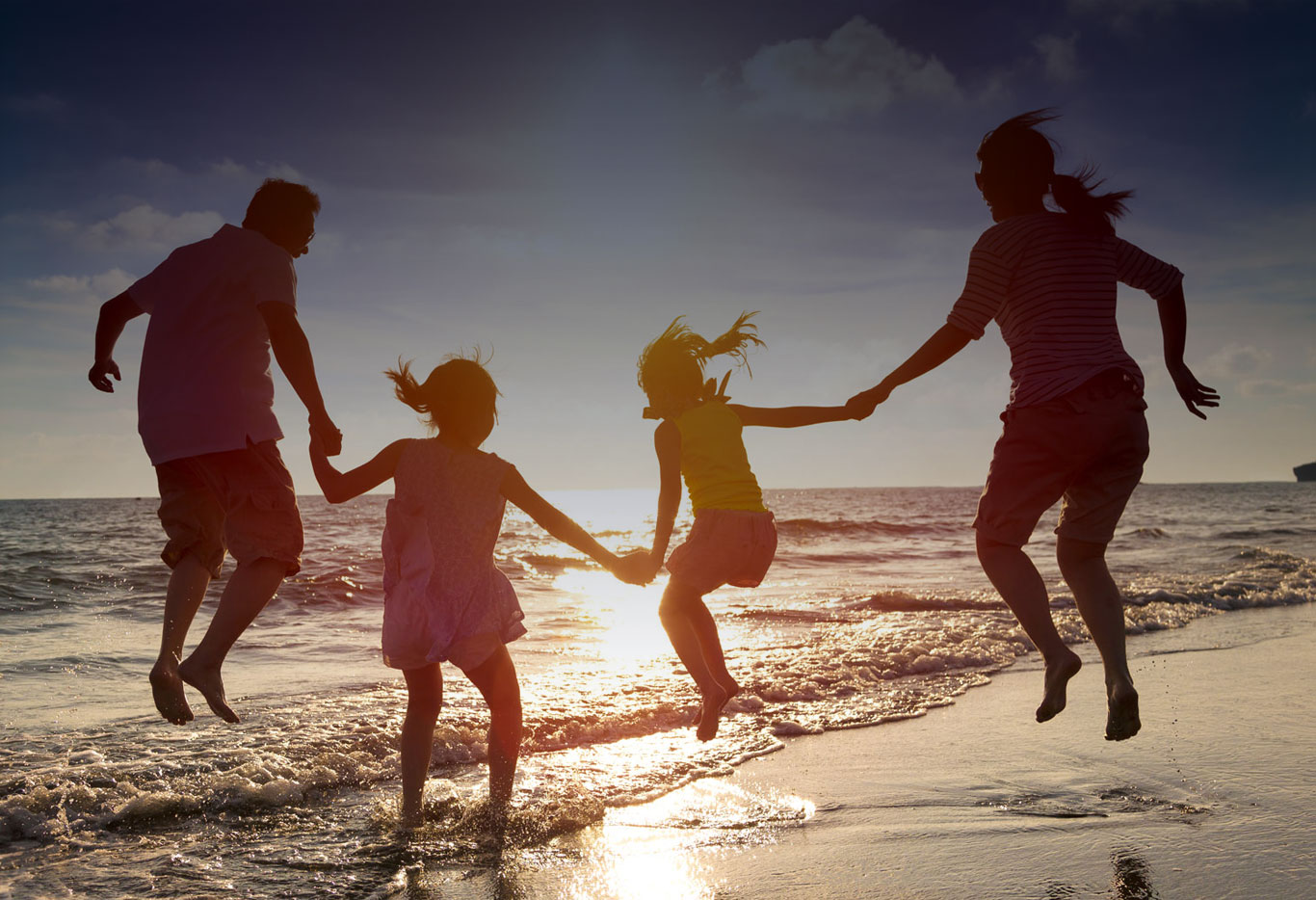 Family on the beach enjoying Waterside Holidays.